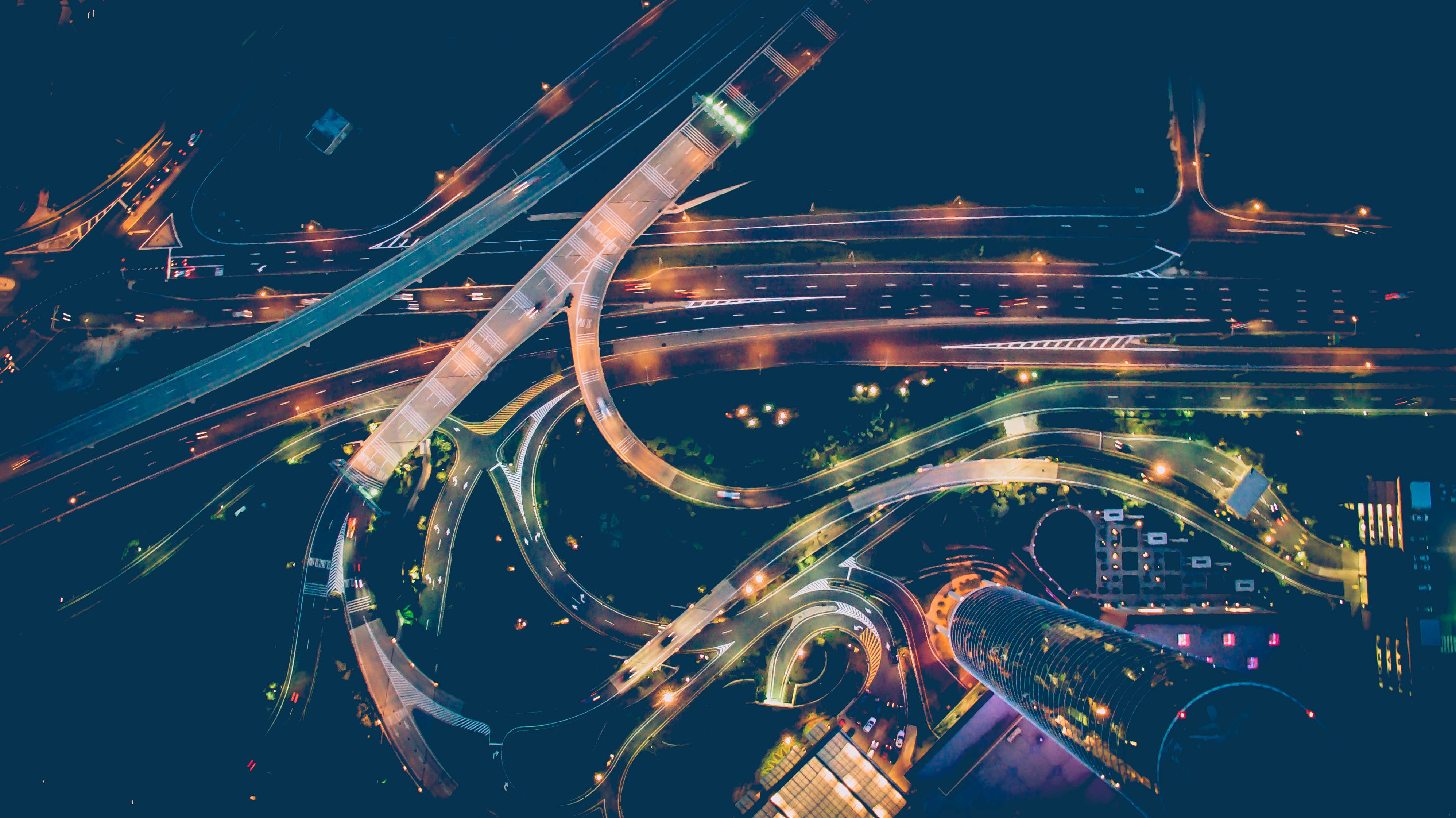 Road junction at night illuminated by street lights