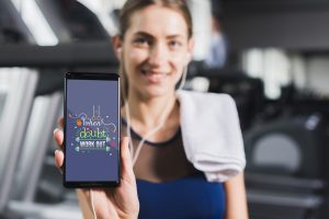 Woman holding a smartphone with motivation slogan to make a workout