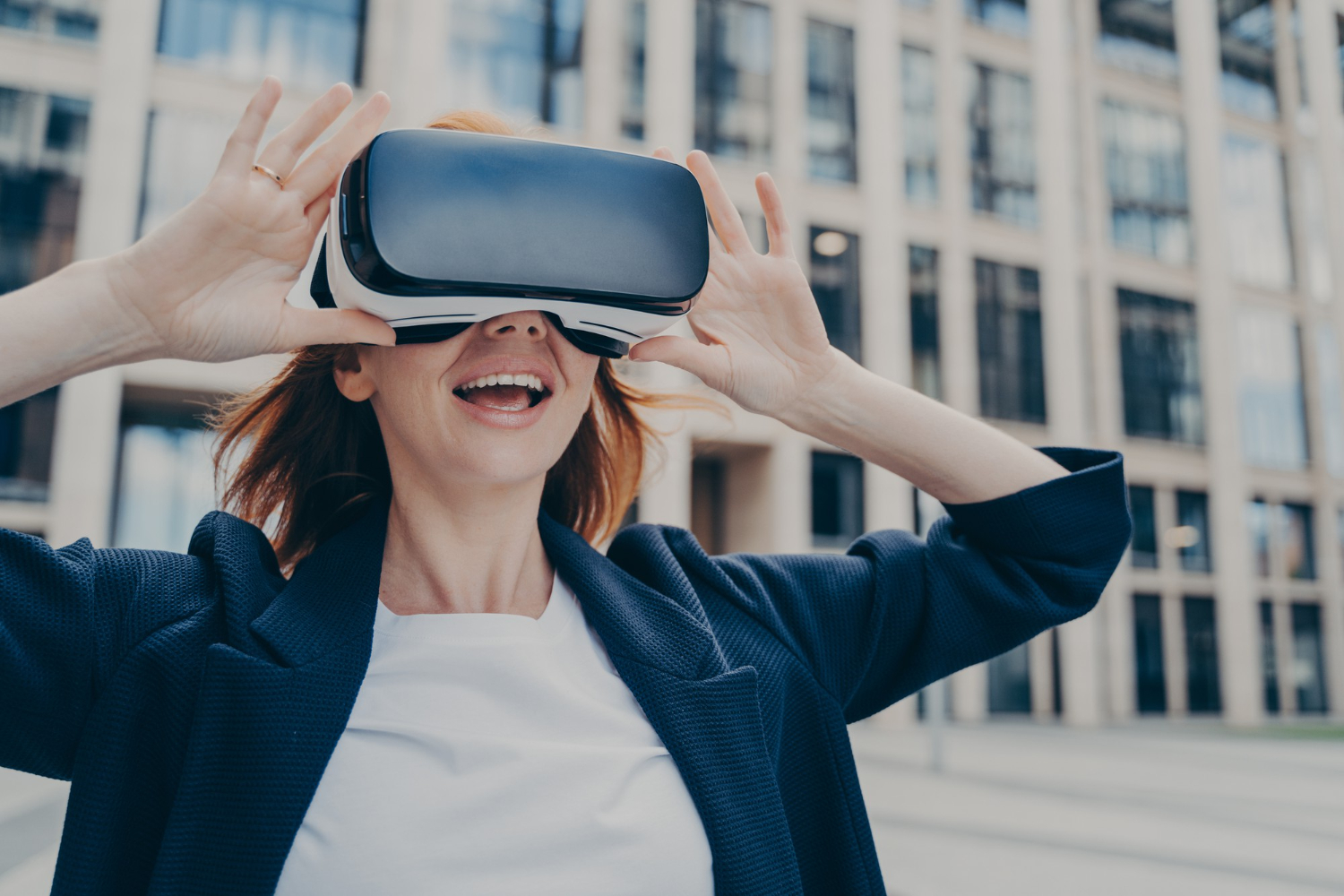 Excited businesswoman exploring a residential area with vr headset