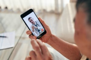 man-use-telemedicine-app-to-meet-his-doctor-in-a-video-call-via-smartphone